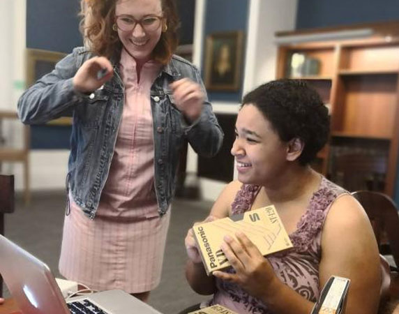 two women digitizing vhs tapes