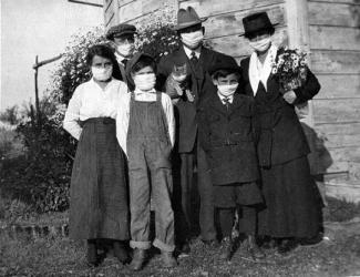 Family wearing masks, including the cat